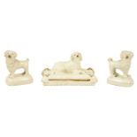 AN EARLY 19TH CENTURY BLANC DE CHINE PORCELANEOUS RECUMBENT DOG AND A PAIR OF MINIATURE POODLES