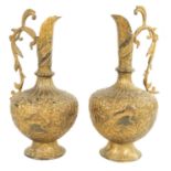 A PAIR OF 19TH CENTURY INDIAN GILT METAL EWERS