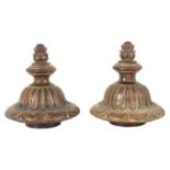 A PAIR OF 19TH CENTURY CARVED MAHOGANY AND GILT HIGH-LIGHTED VASE COVERS