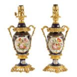 A PAIR OF 19TH CENTURY CONTINENTAL ORMOLU MOUNTED PORCELAIN LAMP BASES