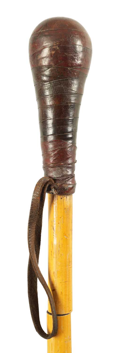 AN EARLY 20TH CENTURY BAMBOO AND LEATHER DAGGER STICK