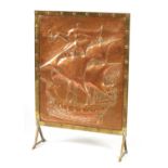 AN ARTS AND CRAFTS COPPER FIRE SCREEN IN THE MANNER OF NEWLYN SCHOOL