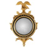 A FINE REGENCY GILTWOOD CONVEX HANGING MIRROR