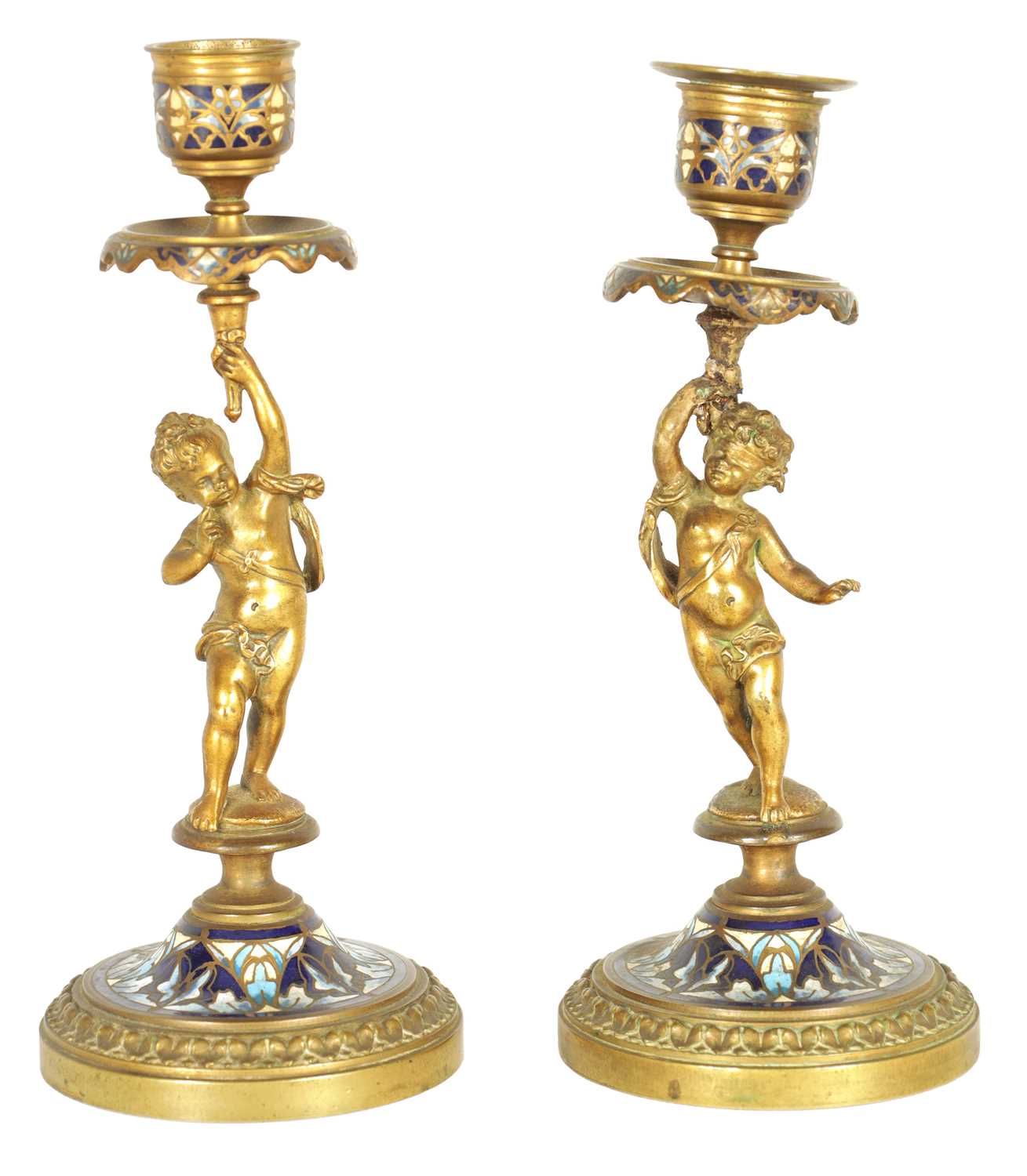 A PAIR OF 19TH CENTURY FRENCH FIGURAL GILT BRONZE AND CHAMPLEVE ENAMEL CANDLESTICKS