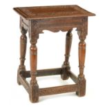 A 19TH CENTURY CARVED OAK JOINT STOOL