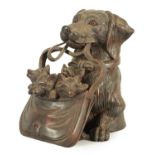 A FINELY CARVED 19TH CENTURY BLACK FOREST DOGS HEAD INKWELL