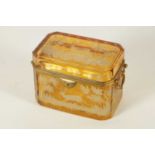 A 19TH CENTURY BOHEMIAN AMBER GLASS OVERLAY CASKET