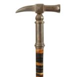 A LATE 19TH CENTURY SEGMENTED HORN WALKING STICK WITH PATINATED METAL HAMMER HEAD HANDLE