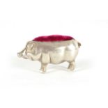 A SMALL EDWARDIAN SILVER PIN CUSHION IN THE FORM OF A PIG