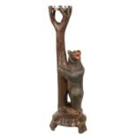 A 19TH CENTURY LINDEN WOOD BLACK FOREST CARVED BEAR JARDINIERE STAND