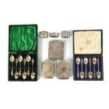 TWO BOXED COLLECTIONS OF SIX SILVER TEASPOONS, THREE SILVER CIGARETTE CASES AND THREE SILVER NAPKIN