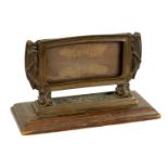 A STYLISH ARTS AND CRAFTS BRONZE CARD DISPLAY STAND