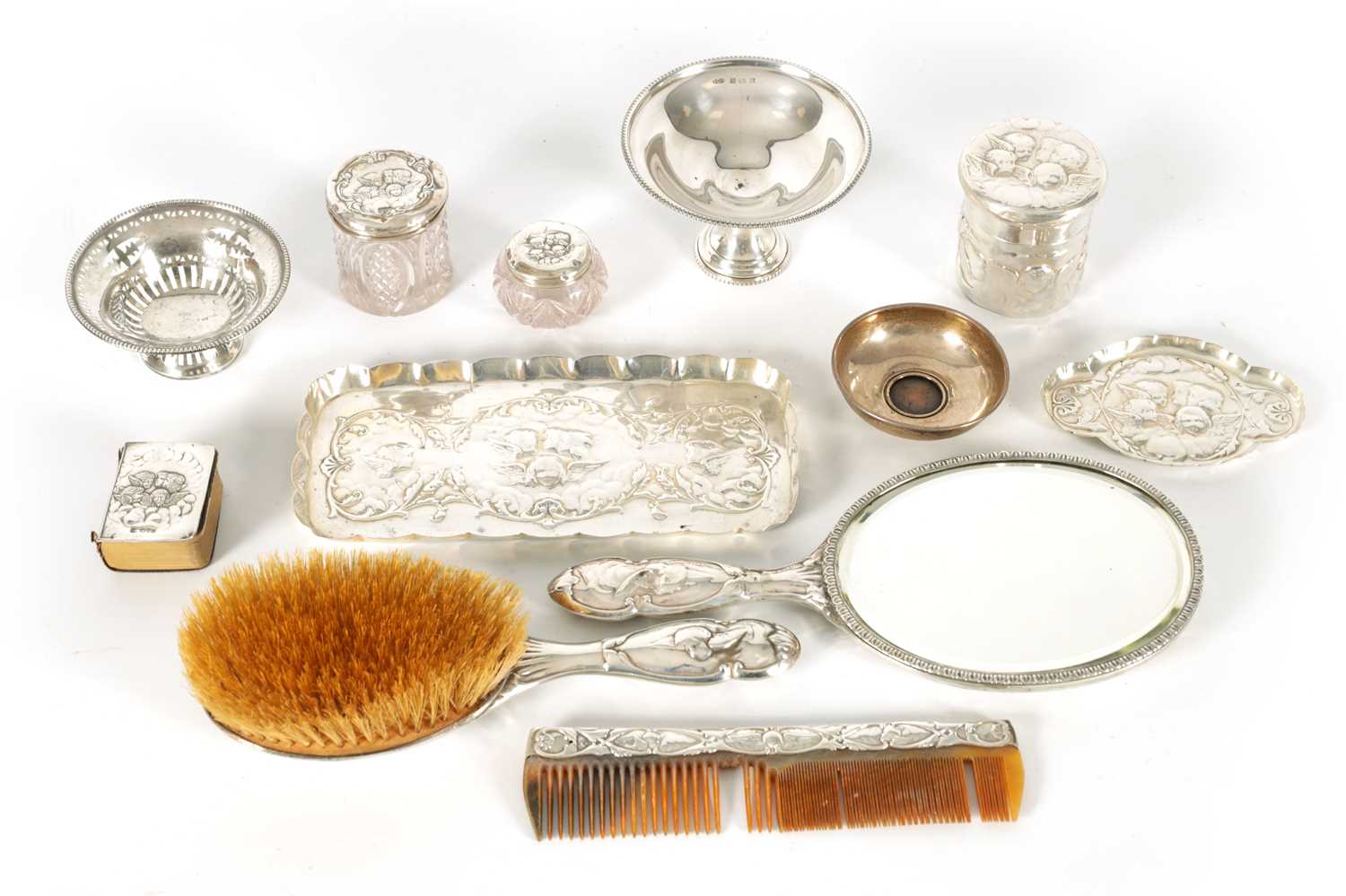 AN ART NOVEAU SILVER NINE PIECE DRESSING TABLE SET