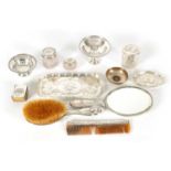 AN ART NOVEAU SILVER NINE PIECE DRESSING TABLE SET