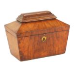 A LATE REGENCY FIGURED OAK SARCOPHAGUS SHAPED TEA CADDY