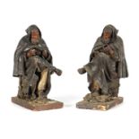 A PAIR OF EARLY PRESSED LEATHER CREICHE SEATED FIGURES