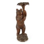 A LATE 19TH CENTURY CARVED BLACK FOREST BEAR JARDINIERE STAND