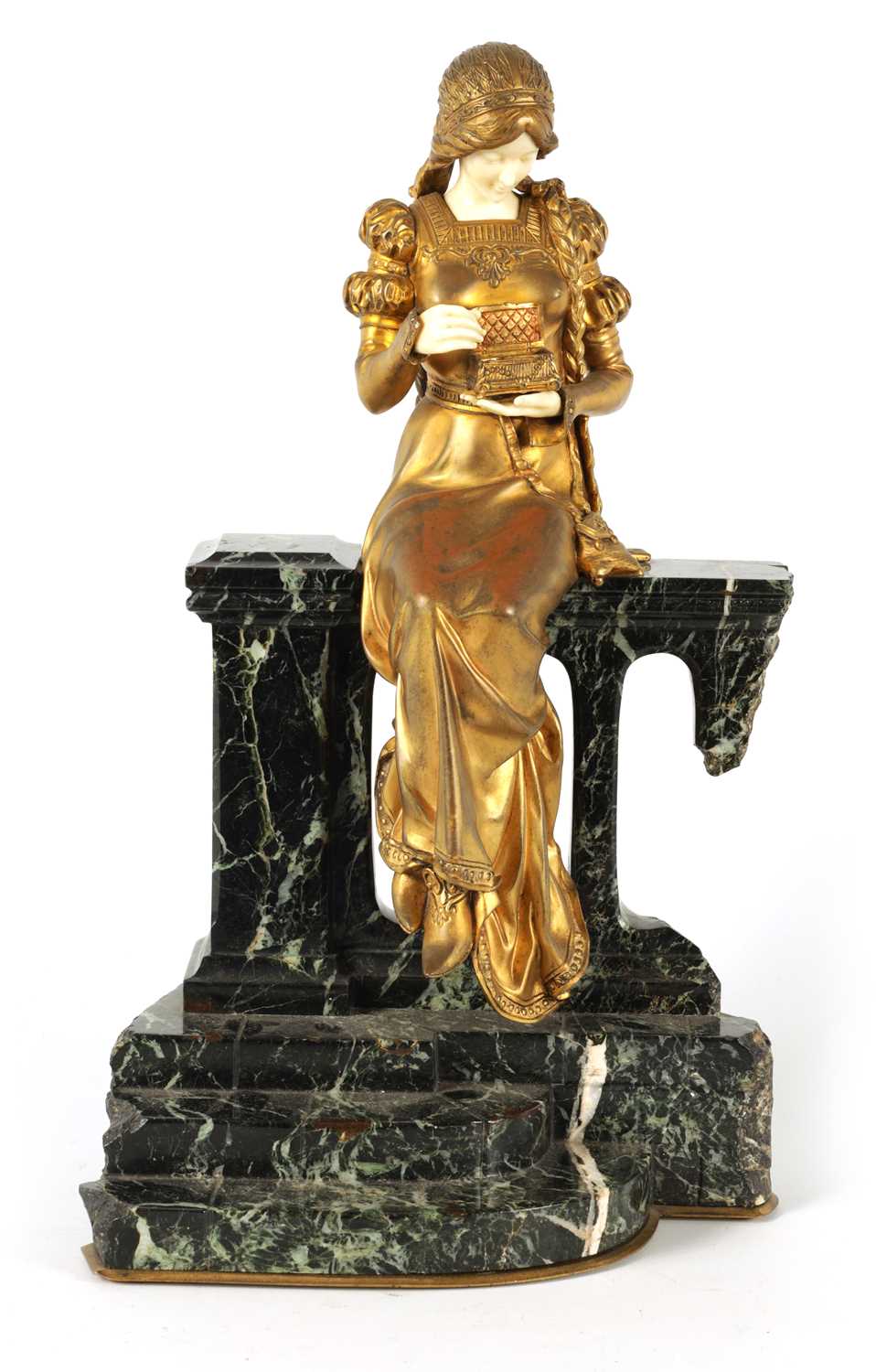 A LATE 19TH CENTURY ART NOUVEAU GILT BRONZE AND IVORY FIGURE OF A SEATED YOUNG LADY