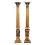 A PAIR OF 19TH CENTURY OAK AND GILT HIGH-LIGHTED CARVED CORINTHIAN COLUMNS