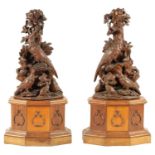 A LARGE PAIR OF LATE 19TH CENTURY CARVED BLACK FOREST CANDLE STANDS