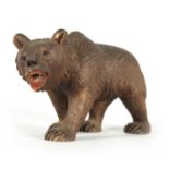 AN EARLY 20TH CENTURY CARVED BLACK FOREST BEAR