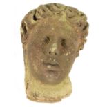 AN EARLY ROMANESQUE STYLE CARVED STONE HEAD