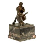 AN EARLY 20TH CENTURY FIGURAL BRONZE SCULPTURE OF AN INDUSTRIALIST