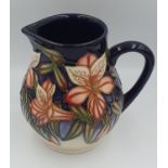 Moorcroft Jug decorated with trumpet flowers, impressed green mark to base C.2003. 11.5cm in Height