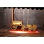 Brass model of Stephenson's Rocket mounted on wooden base