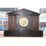 Belgian Slate mantel clock with column supports and Numeral Dial. 43cm in Diameter