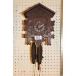 Small Black forest clock with pendulum and weights