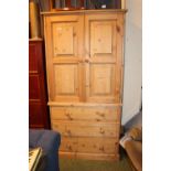 Pine Linen press of 2 cupboard doors over 3 drawers with turned handles