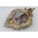 Ornate Gesso floral decorated fame with inset Hand painted plate with Terrier and child. 42cm in