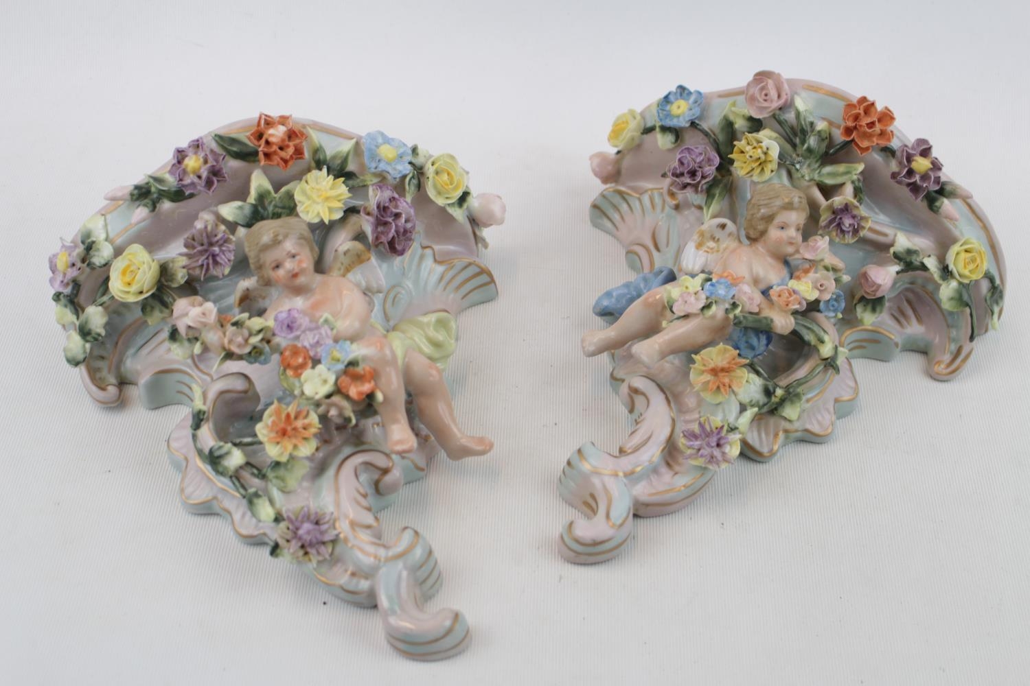 Pair of Meissen style Cherub decorated floral garnitures sconces