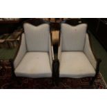 Pair of Edwardian Walnut Inlaid upholstered elbow chairs on tapering legs and casters