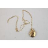 Ladies Yellow metal oval locket on 9ct gold chain