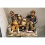 Large Capodimonte figurine of two inebriated elderly gentlemen on a park bench