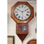 Octagonal Walnut cased wall clock with roman numeral dial over leaded glass with Pendulum and Key