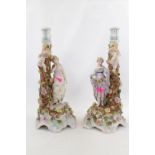 Pair of 19thC European figural decorated candlesticks decorated with a profusion of floral