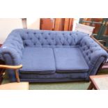 Blue upholstered drop end sofa on bun caster feet