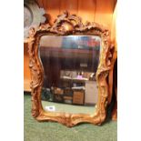 Ornate Gilt Gesso framed wall mirror of swaggered decoration
