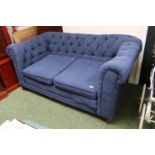 Blue upholstered drop end sofa on bun caster feet