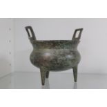 Chinese bronze censor with gilt splash decoration, upturned handles over Tri peg base. 11cm in