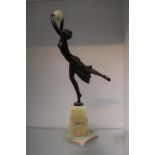 Art Deco Bronzed figure of a dancer with Onyx ball over green Onyx base. Repair to foot. 36cm in