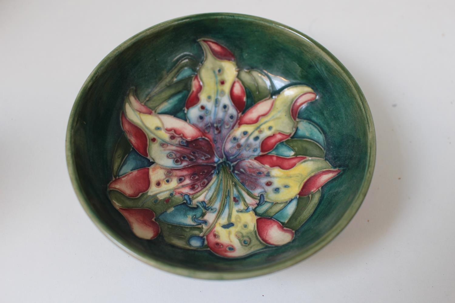 Moorcroft Nut dish with floral decoration on green ground with impressed mark to base