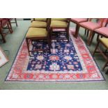 Good quality Red and blue ground rug with floral geometric border
