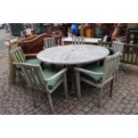 Large Circular teak garden table and six chairs with cushions