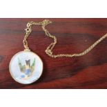 Mother of Pearl circular Bird and Pheasant decorated pendant set on 9ct Gold Chain