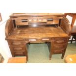 1920s Oak Roll top desk with fitted interior over pedestal base