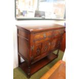 Oak sideboard with carved panel doors and under tier